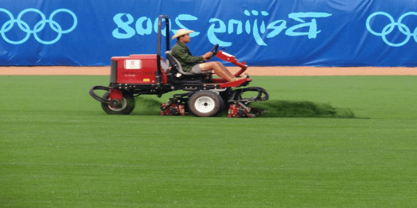 a man mowing riviera grass at the beijing olympics